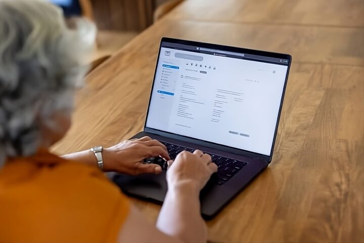A freelancer utilizing newsletter software on his modern computer.